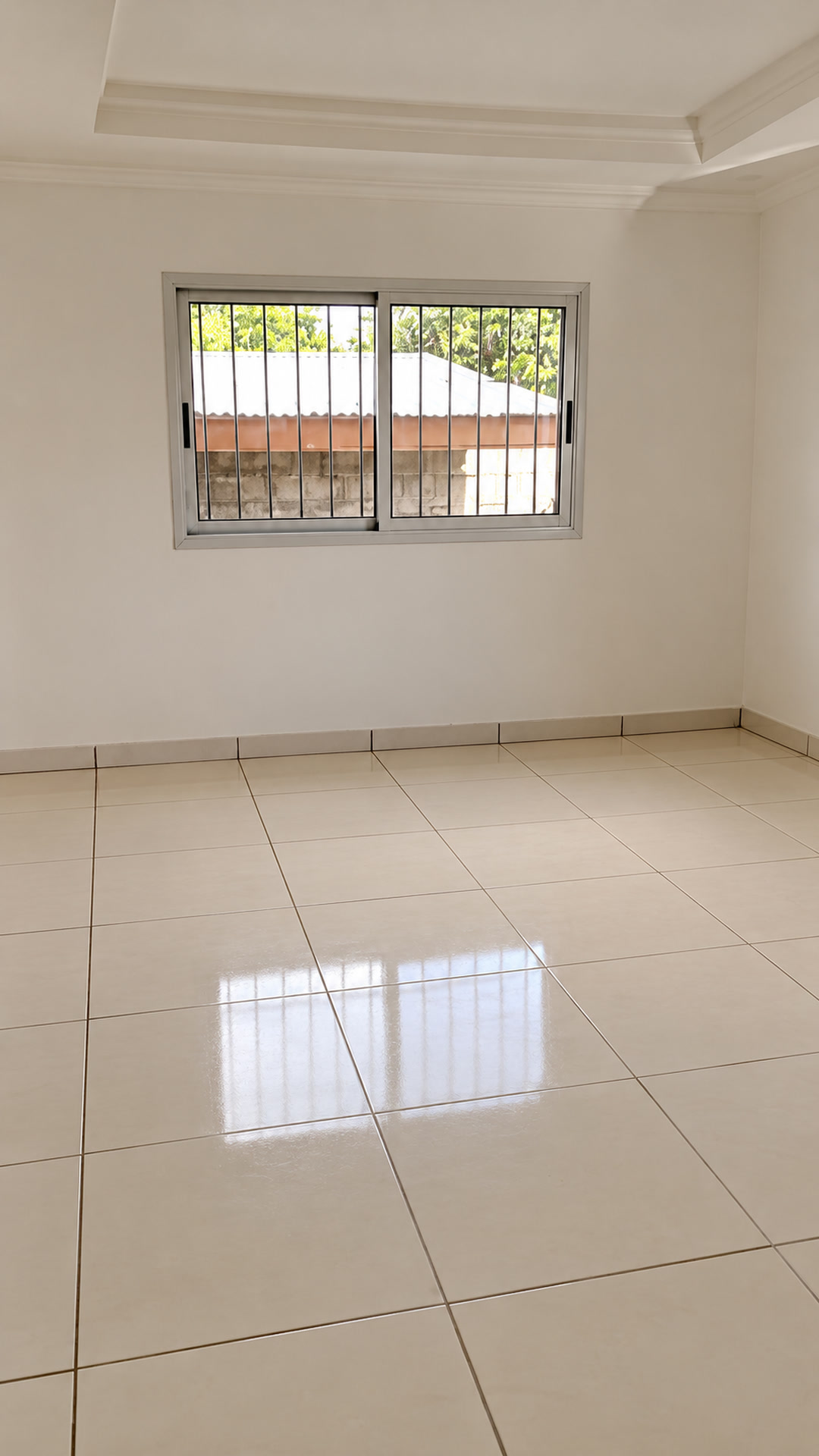 Unfurnished tiled room with a wide window; Enhanced rendition of the owner’s video still