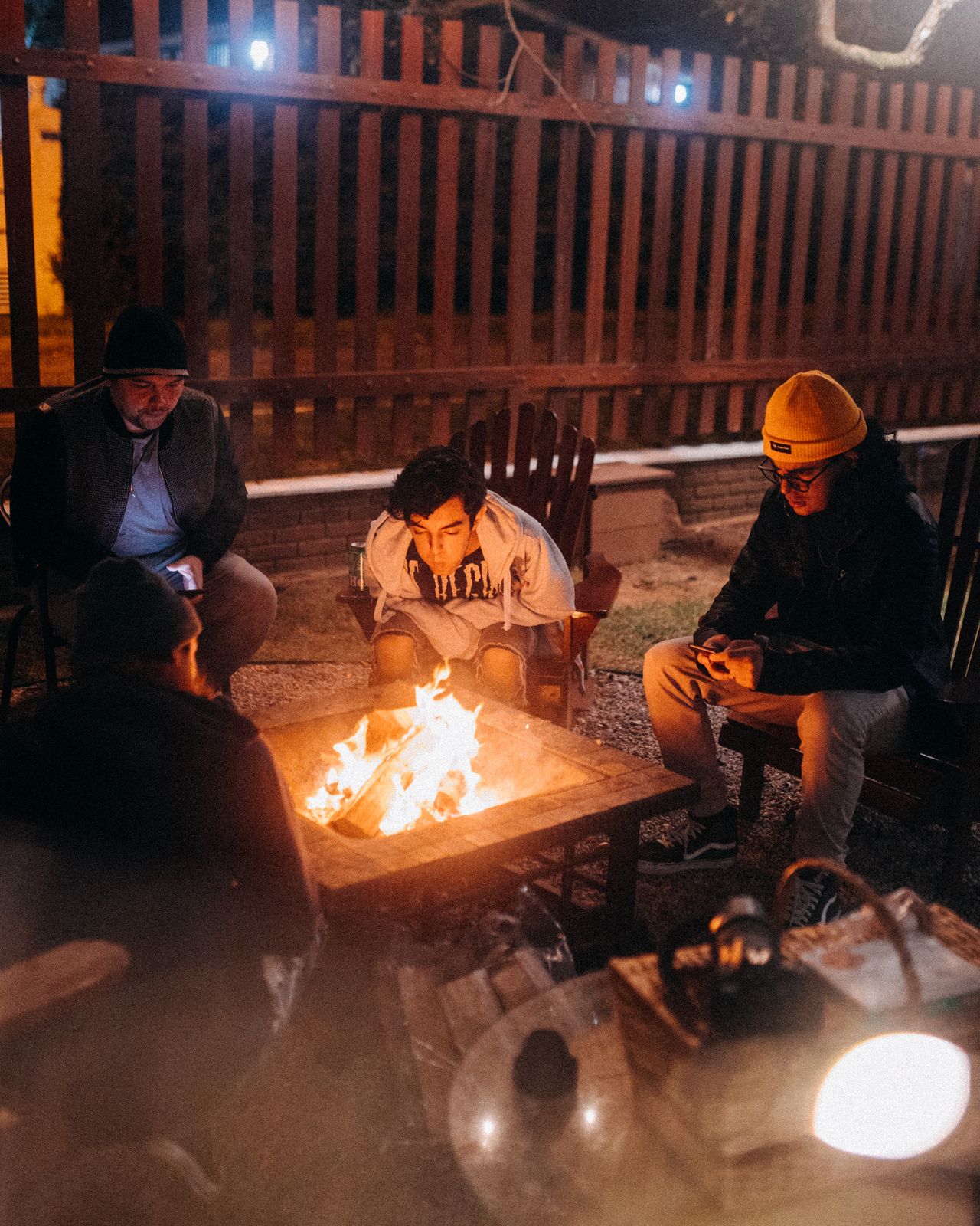 Sample stock photo of people gathered around a bonfire, not a Nelson & Associates event